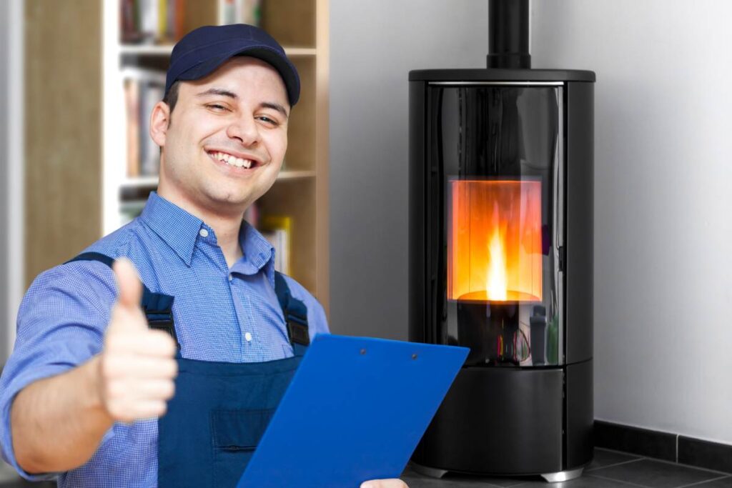 stufa a pellet sullo sfondo ed in primo piano tecnico che fa segno ok