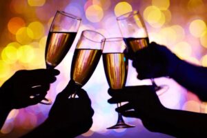 persone che brindano con calici pieni di spumante